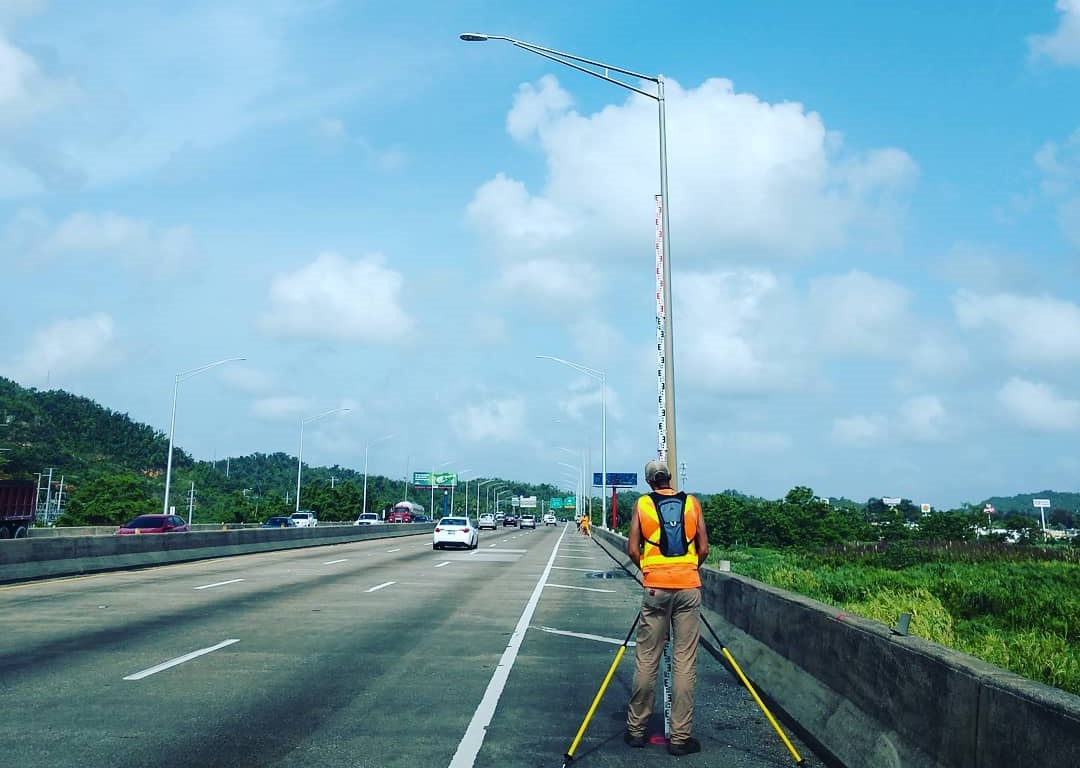 A man standing on the side of a road.